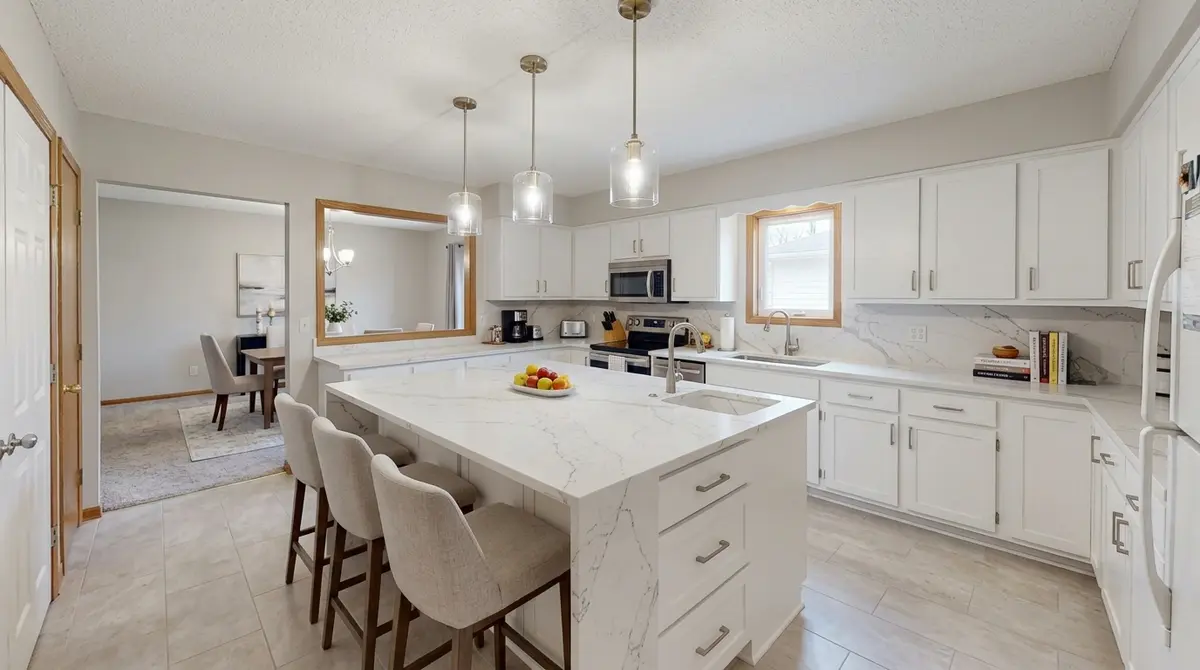 After — custom kitchen island with waterfall quartz countertop and seating, North Mankato, MN