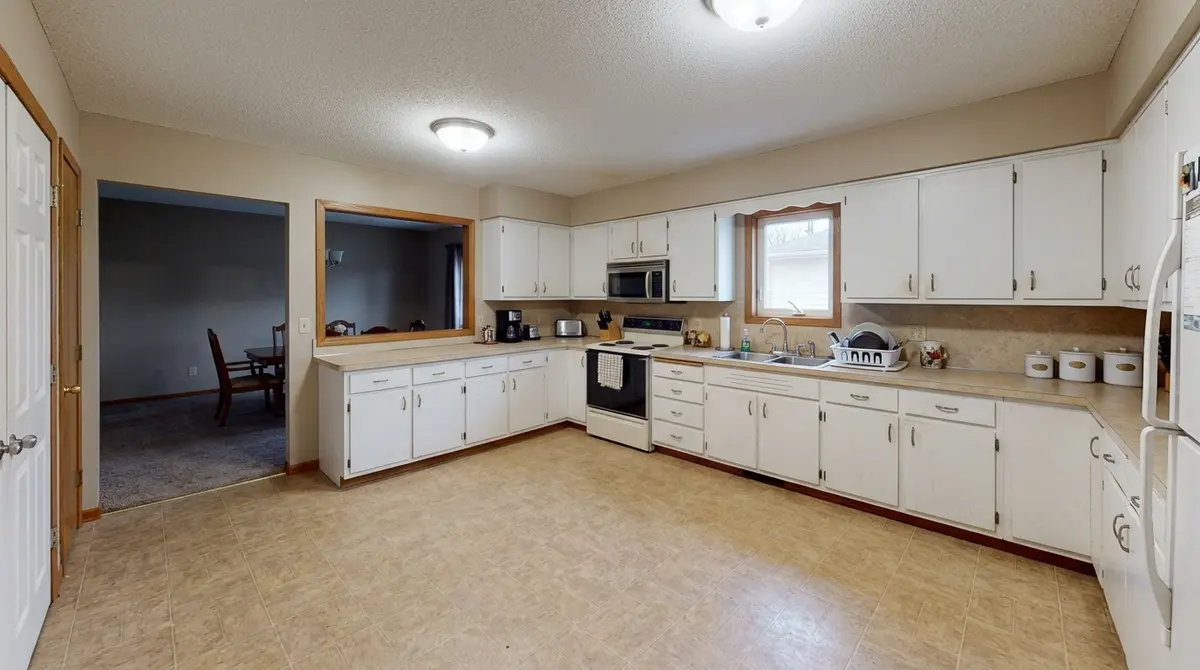 Before — open kitchen floor space with no island, North Mankato home before kitchen remodel